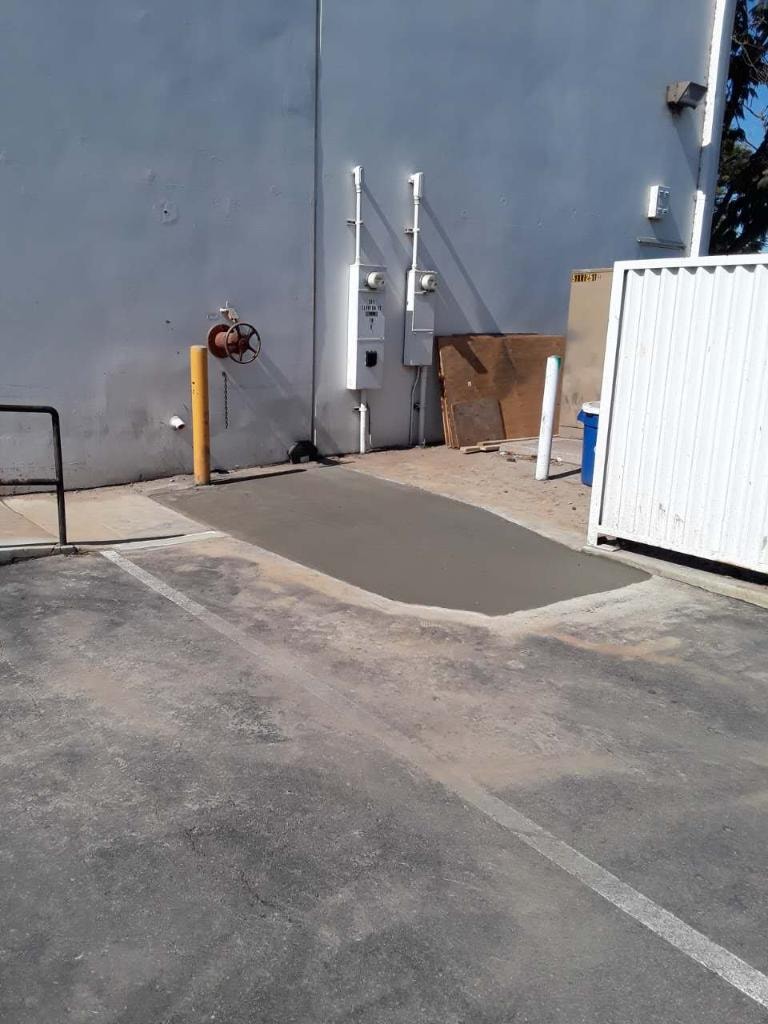 Fresh concrete restoration patch after 6-inch waterline repair — Orange County CA