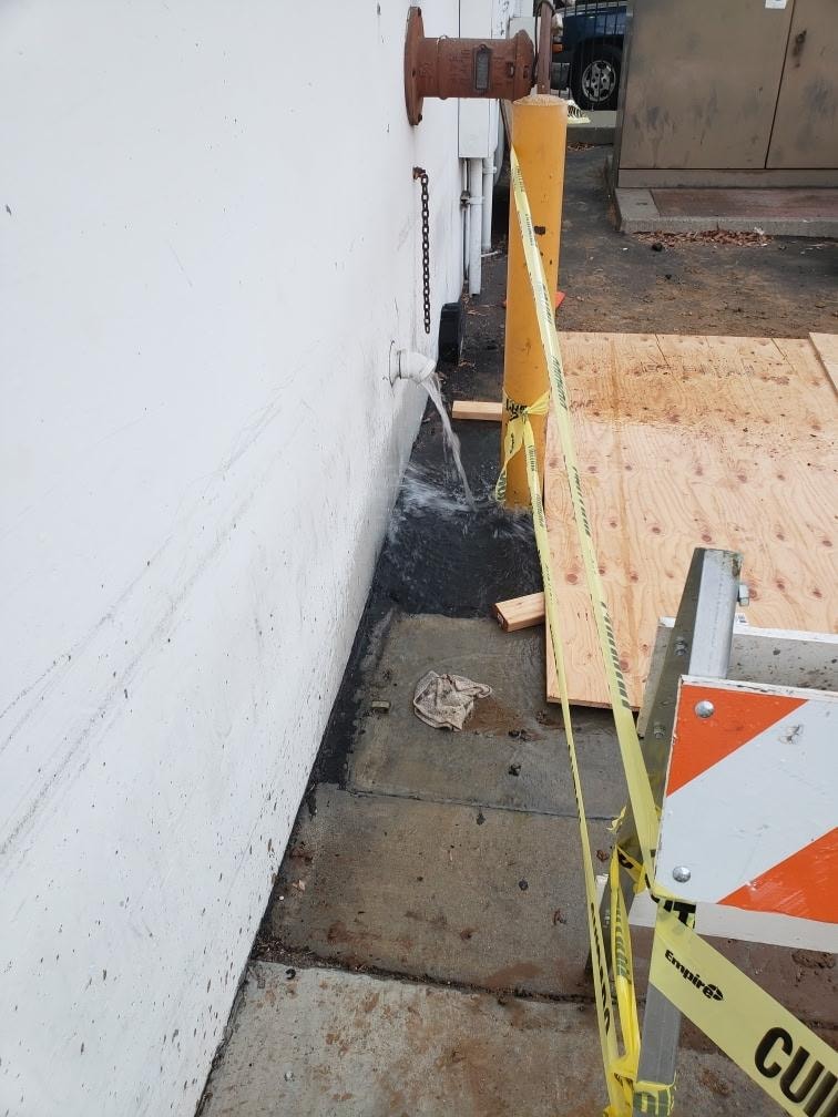 Active 6-inch waterline break with caution tape and safety barriers — Orange County CA