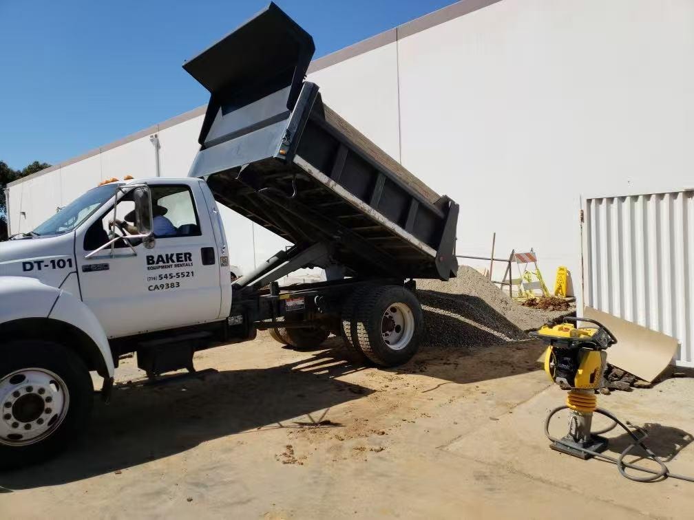 Baker Equipment dump truck delivering gravel backfill — waterline repair Orange County CA