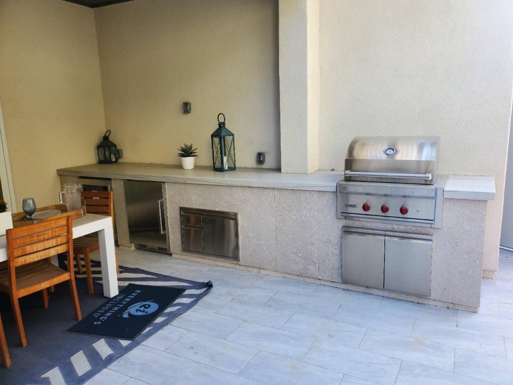 Finished outdoor kitchen with built-in grill, pavers, and custom exterior finishes — Irvine CA