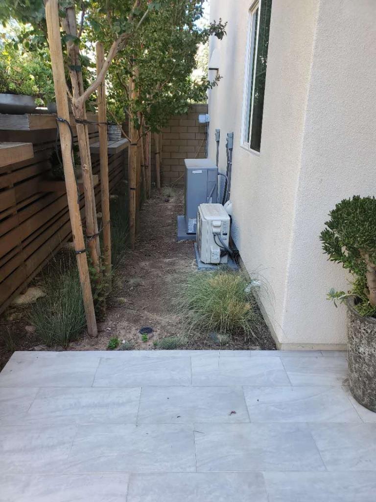 Finished side yard with paver tile flooring and landscaping — Irvine CA