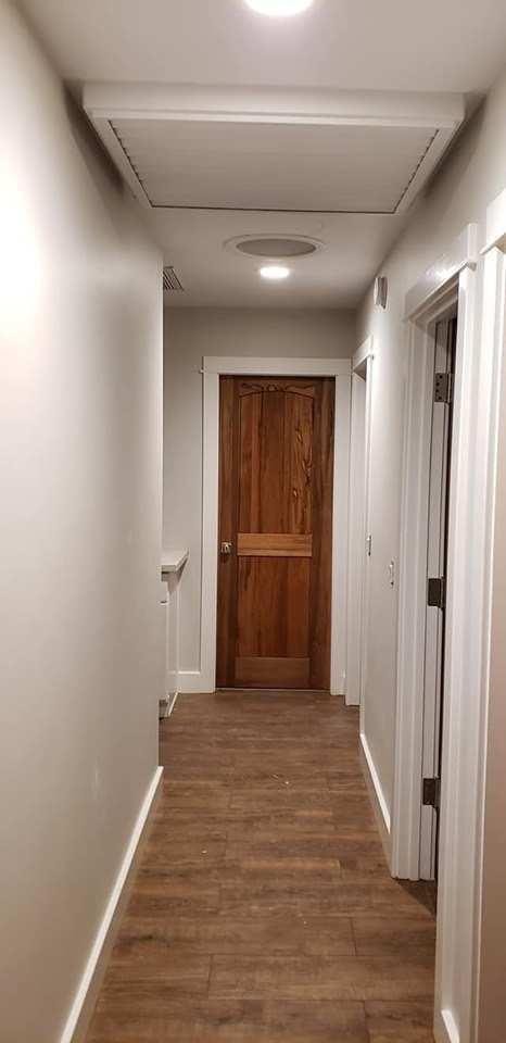 Completed hallway with wood flooring, recessed lighting, and finish trim — Orange County CA