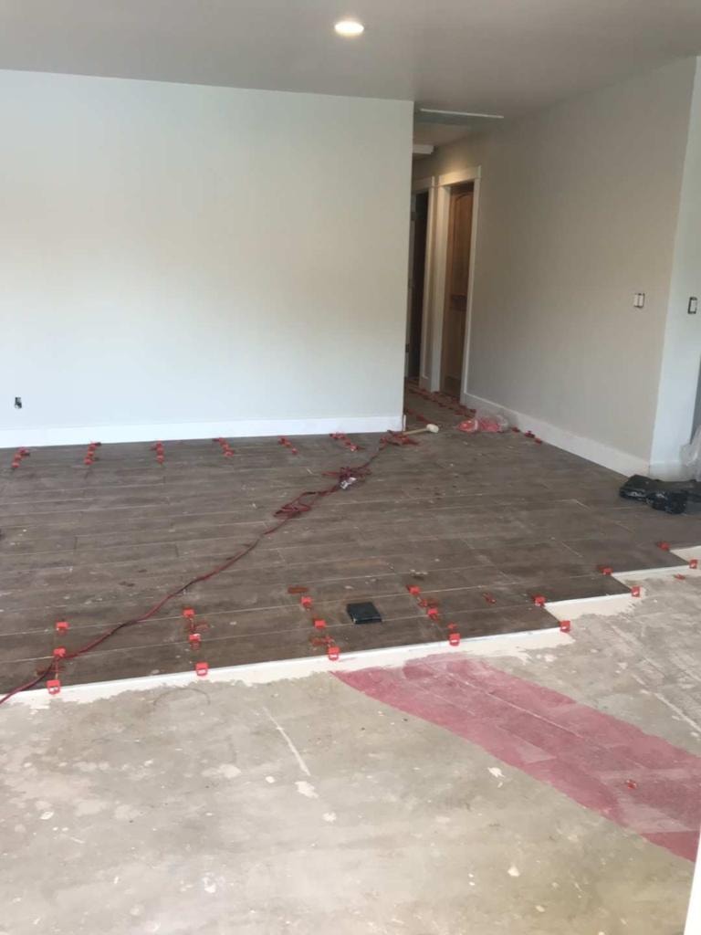 Large format tile flooring installation with leveling spacers — Orange County CA